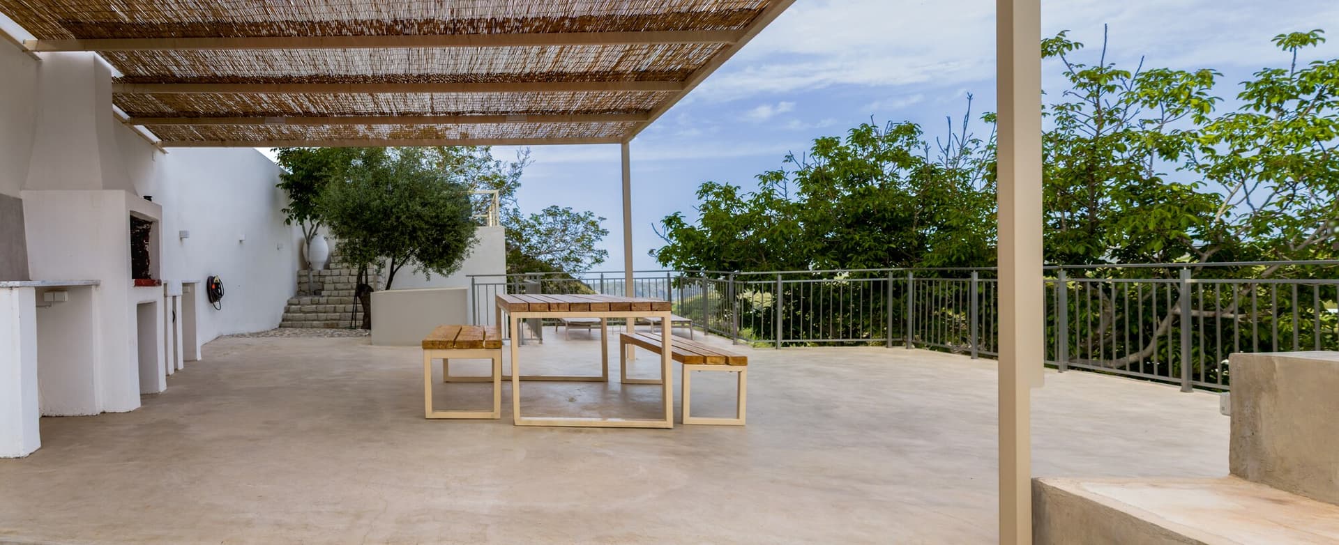 Covered dining terrace with valley view beyond