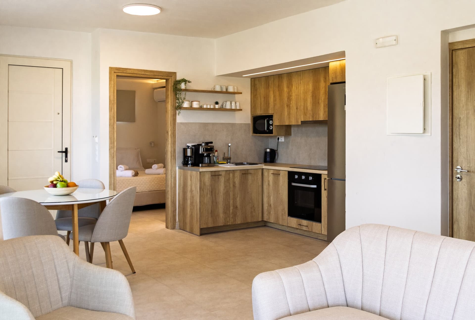 Kitchen and dining area with the bedroom visible through the doorway